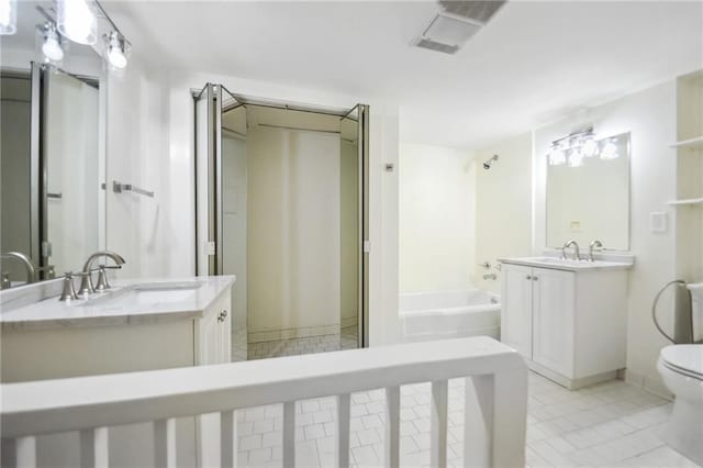 bathroom with vanity, a bathtub, tile patterned flooring, and toilet