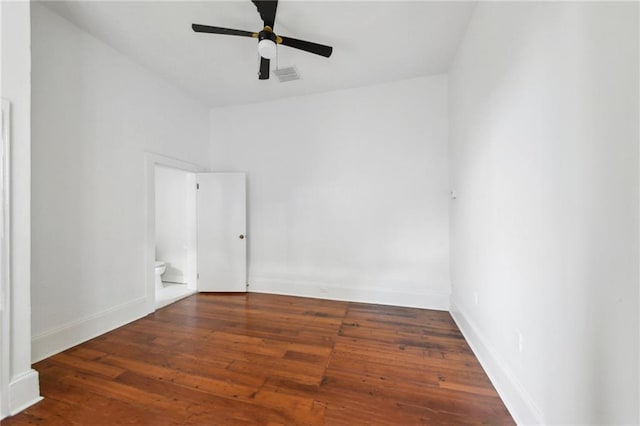 empty room with ceiling fan and dark hardwood / wood-style floors