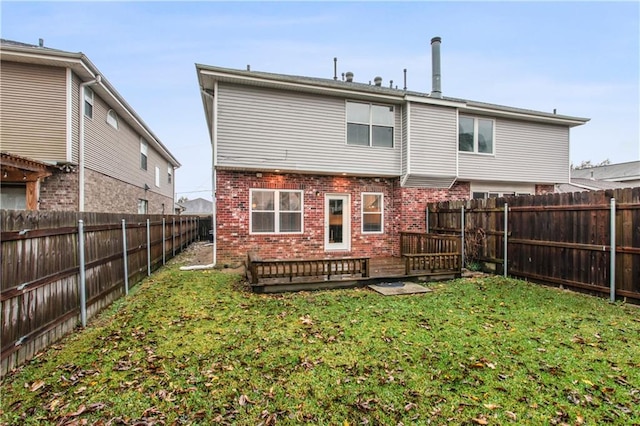 rear view of property featuring a yard