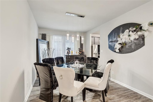 dining area with wood-type flooring