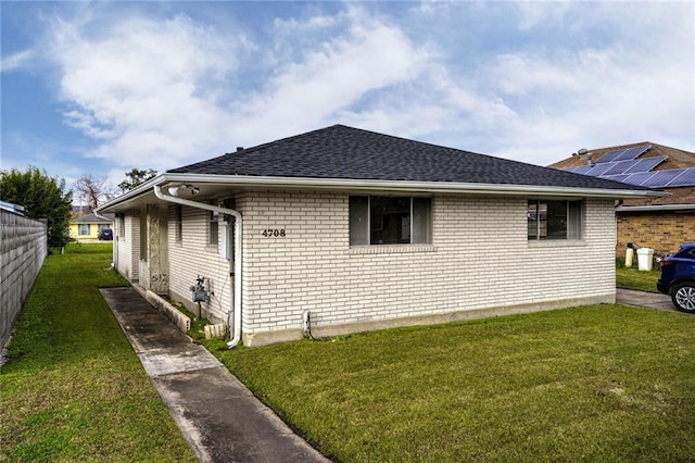 view of side of home featuring a yard