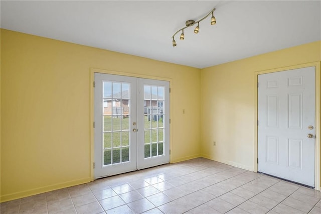 doorway to outside featuring french doors and light tile patterned flooring