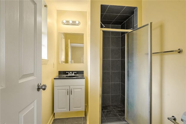 bathroom with tile patterned floors, vanity, and a shower with shower door