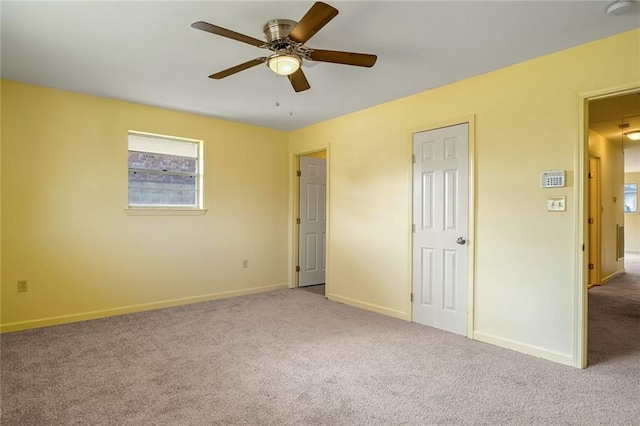 unfurnished bedroom featuring ceiling fan and light carpet