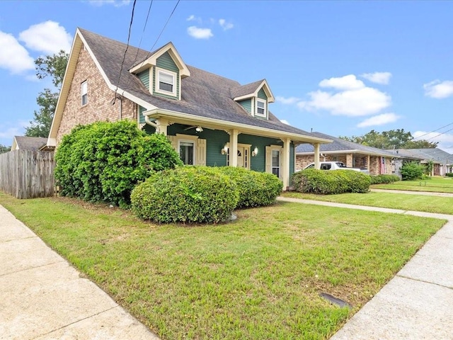 cape cod-style house with a front lawn and covered porch