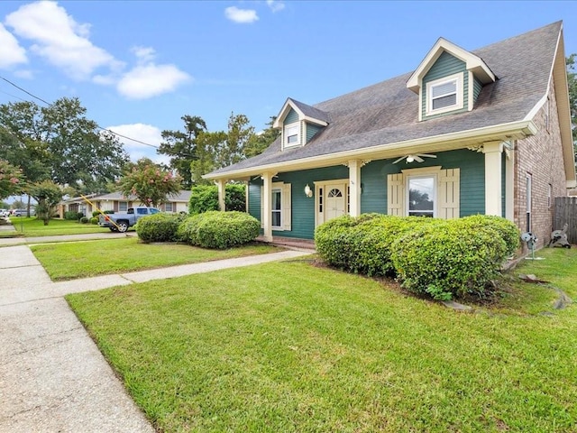 new england style home featuring a front lawn and covered porch