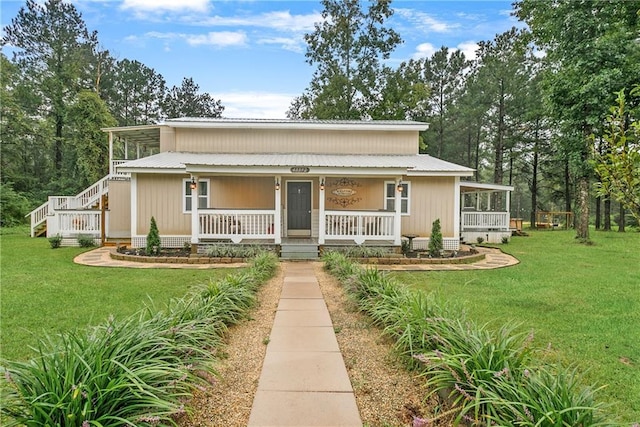 view of front of property with metal roof, a porch, and a front lawn