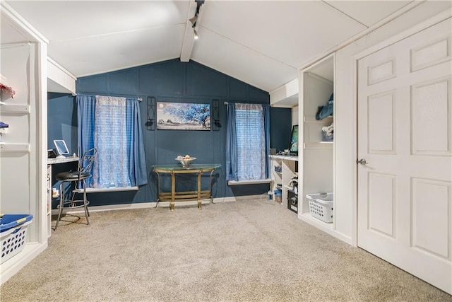 carpeted bedroom with vaulted ceiling with beams