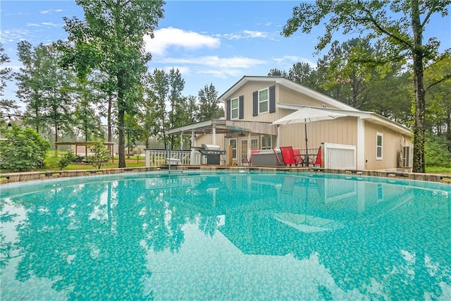 view of swimming pool with grilling area