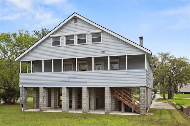 back of property featuring a sunroom and a yard