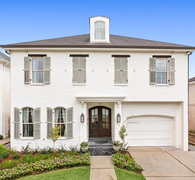 view of front of house with french doors and a garage