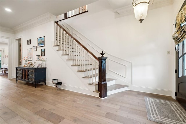 entryway featuring crown molding and wood-type flooring