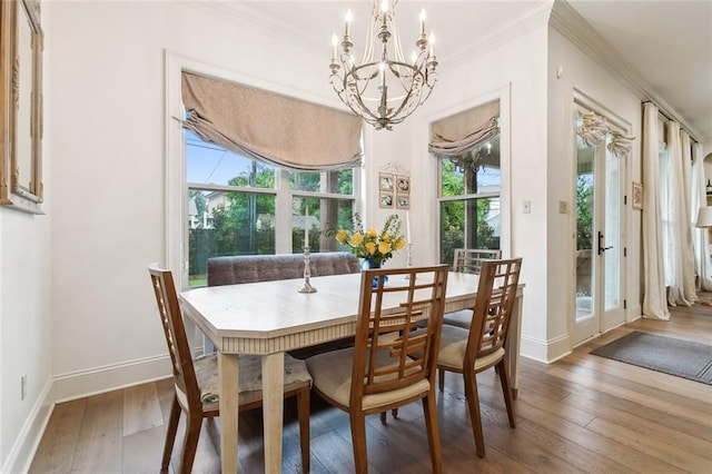 dining space featuring crown molding, a chandelier, and hardwood / wood-style flooring