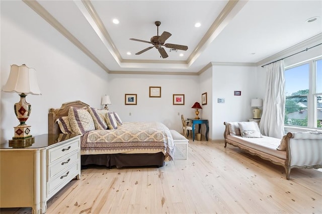 bedroom with a raised ceiling, ceiling fan, light hardwood / wood-style flooring, and ornamental molding