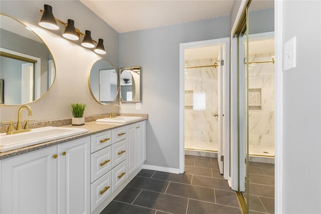 bathroom with vanity, tile patterned flooring, and tiled shower