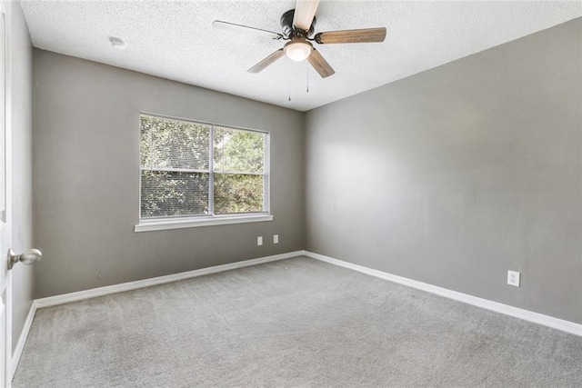 carpeted empty room featuring ceiling fan and a textured ceiling