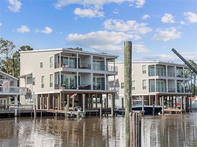 rear view of property with a balcony and a water view