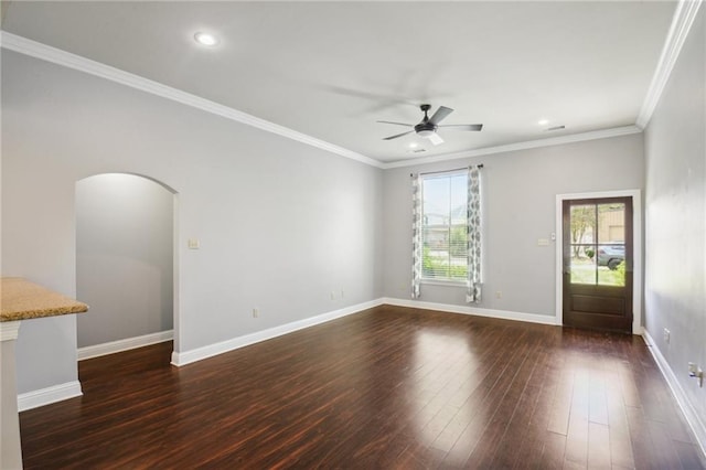 spare room featuring crown molding, ceiling fan, and dark wood-type flooring