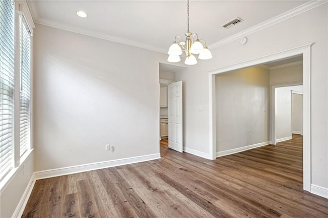 unfurnished dining area with ornamental molding, dark hardwood / wood-style floors, and a chandelier