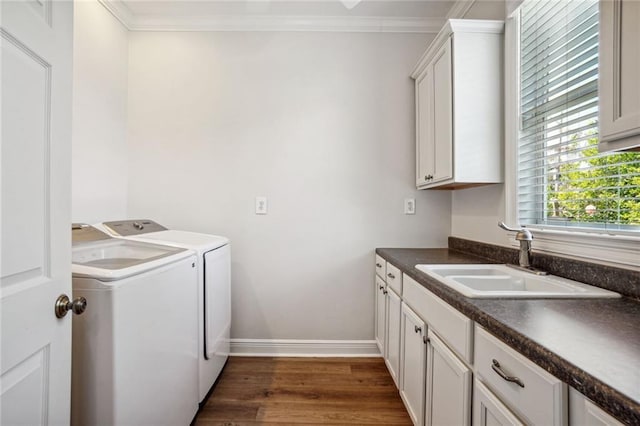 washroom featuring sink, crown molding, independent washer and dryer, and dark hardwood / wood-style floors