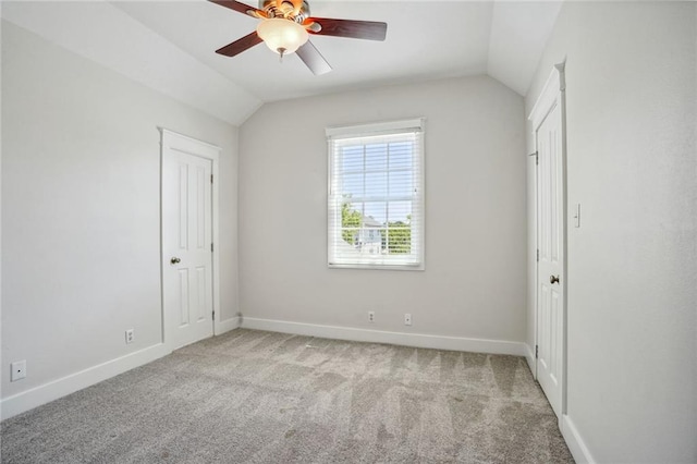 unfurnished bedroom with lofted ceiling, light colored carpet, and ceiling fan