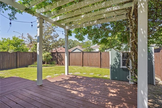 wooden deck with a yard and a pergola