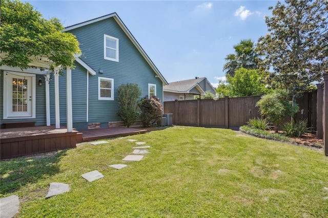 view of yard featuring a wooden deck and central AC unit