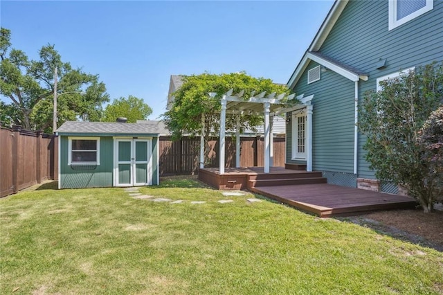 rear view of house featuring a pergola, a storage unit, a wooden deck, and a lawn