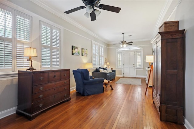 living room with ceiling fan, crown molding, and hardwood / wood-style floors