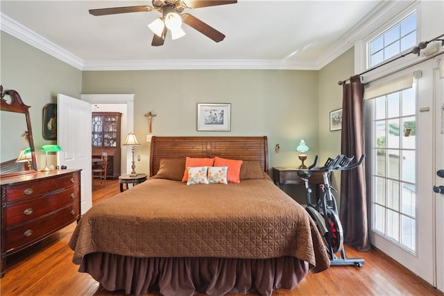 bedroom featuring ceiling fan, light hardwood / wood-style flooring, and crown molding