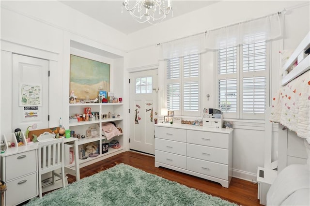 bedroom featuring a notable chandelier and dark hardwood / wood-style flooring