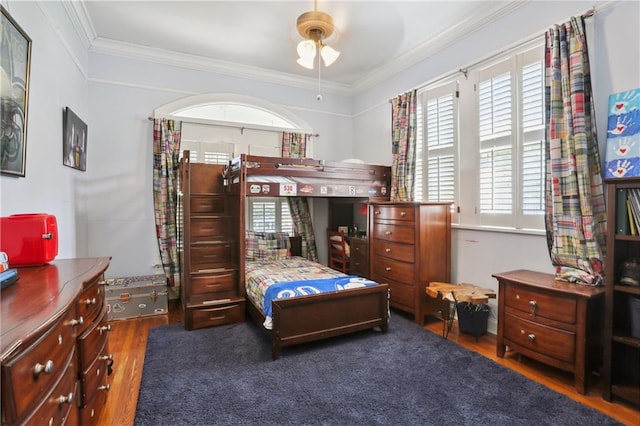 bedroom featuring crown molding, ceiling fan, and dark wood-type flooring