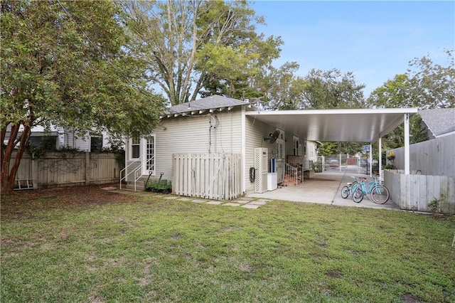 rear view of house with a yard and a carport