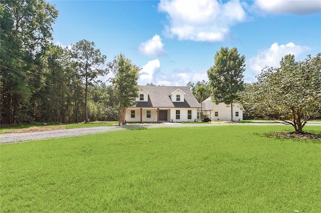 cape cod house featuring a front lawn