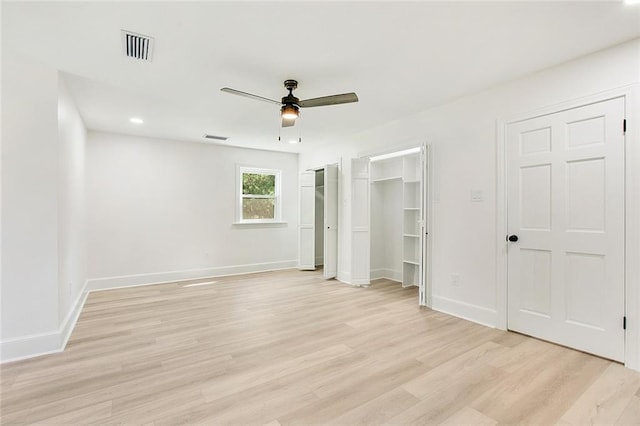 interior space with two closets, light hardwood / wood-style floors, and ceiling fan