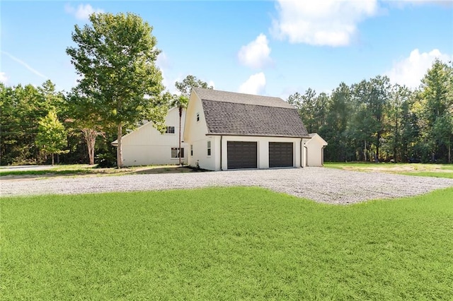 exterior space with a lawn, an outbuilding, and a garage