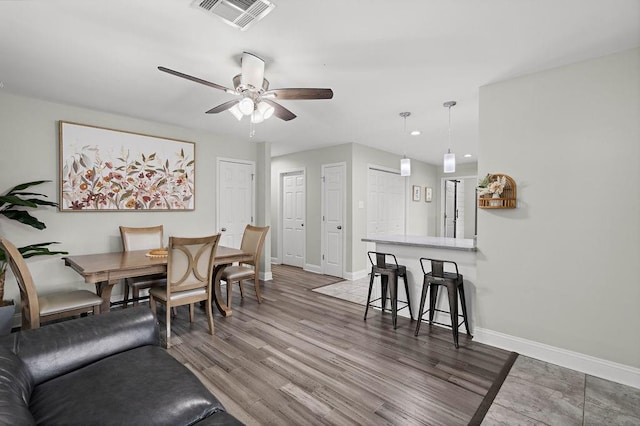 dining area with ceiling fan and hardwood / wood-style flooring