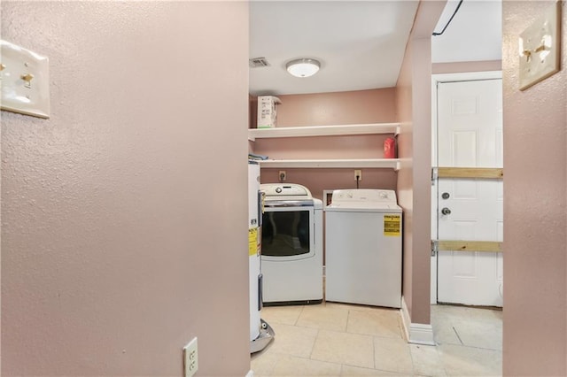 washroom with light tile patterned floors and independent washer and dryer