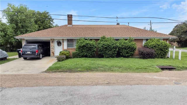 ranch-style house with a garage and a front lawn