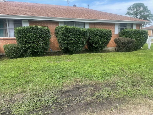 view of property exterior with a yard