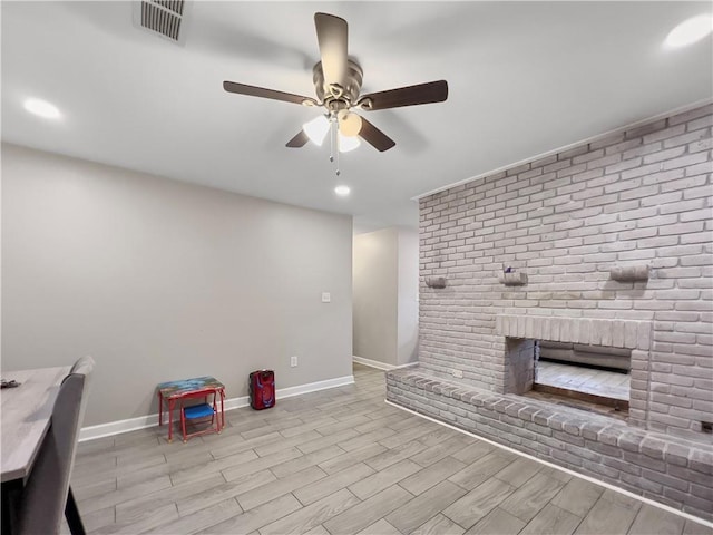 interior space with ceiling fan, light hardwood / wood-style floors, and a fireplace