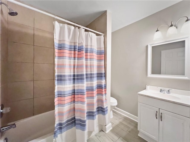 full bathroom with hardwood / wood-style floors, vanity, toilet, and shower / bath combo with shower curtain