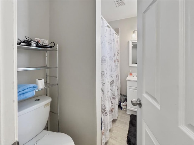 bathroom featuring hardwood / wood-style floors, vanity, and toilet