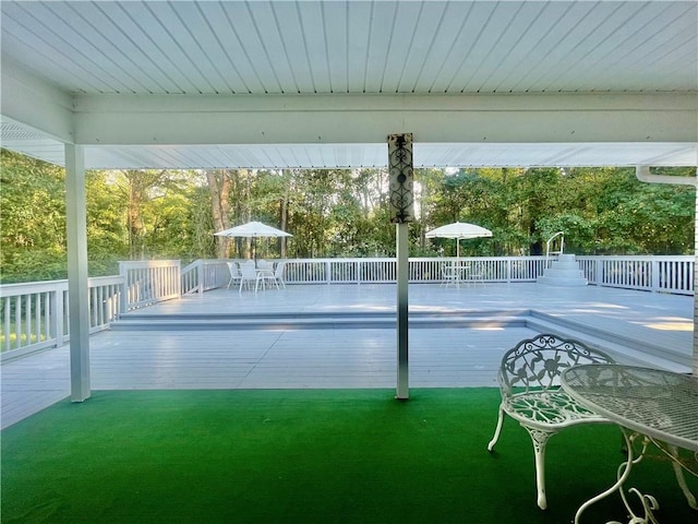 view of swimming pool with a yard and a wooden deck