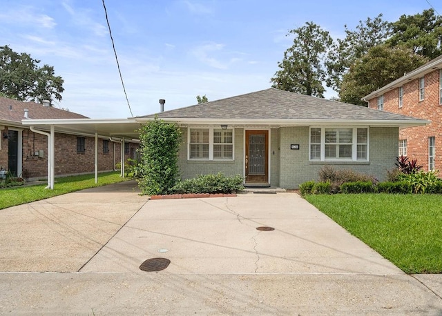 view of front facade with a carport and a front lawn