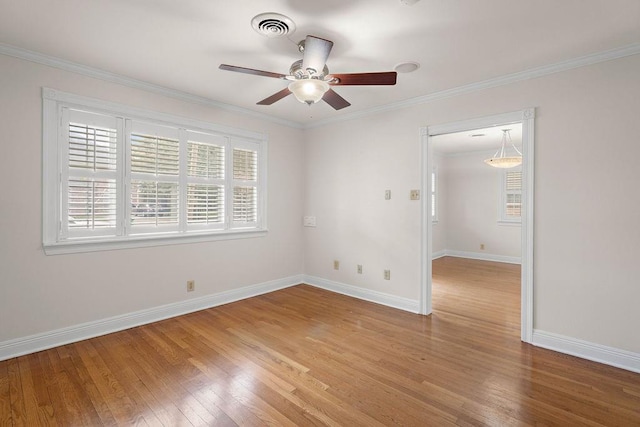 spare room with wood-type flooring, ceiling fan, and crown molding