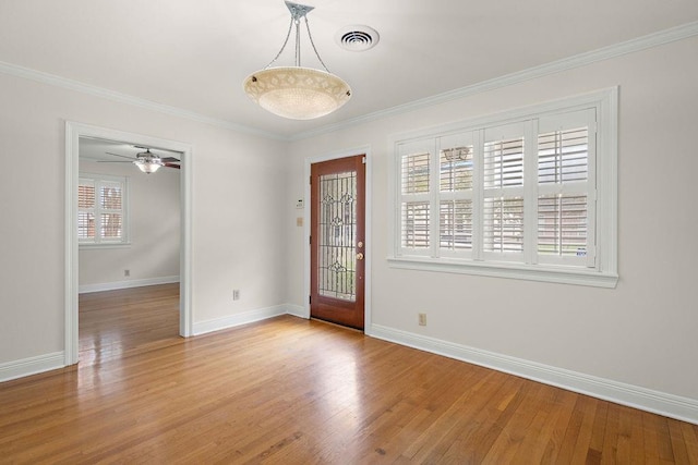 spare room featuring ceiling fan, light hardwood / wood-style flooring, and crown molding