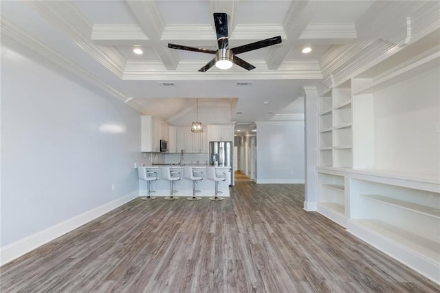 unfurnished living room with ceiling fan, beam ceiling, coffered ceiling, crown molding, and light hardwood / wood-style floors