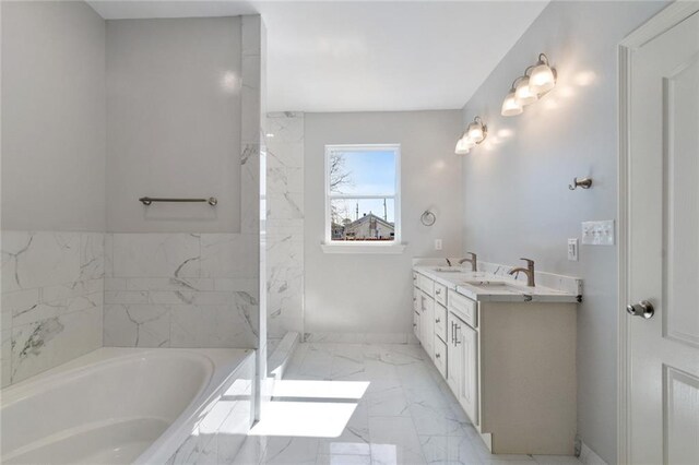 bathroom featuring a tub to relax in and vanity