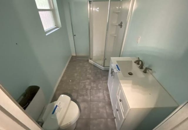 103 W Hickory St, Mandeville, LA 70471 - full bath featuring a shower stall, baseboards, toilet, vanity, and tile patterned flooring